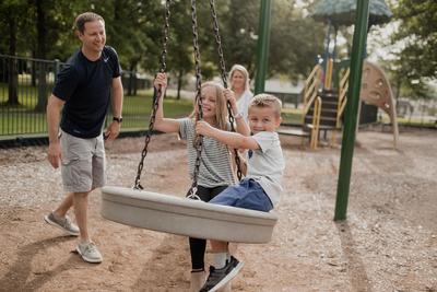 Man playing with children at playgound