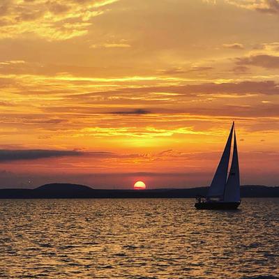 sailboat on the water at sunset