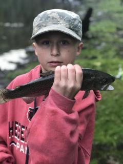 Young boy holding Trout caught on the Little Red River