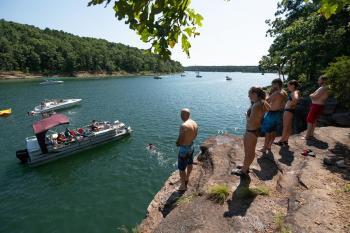 People getting ready to jump from stone cliff
