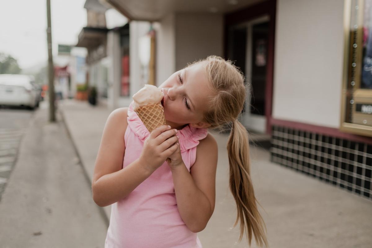 girl eating ice cream on main street
