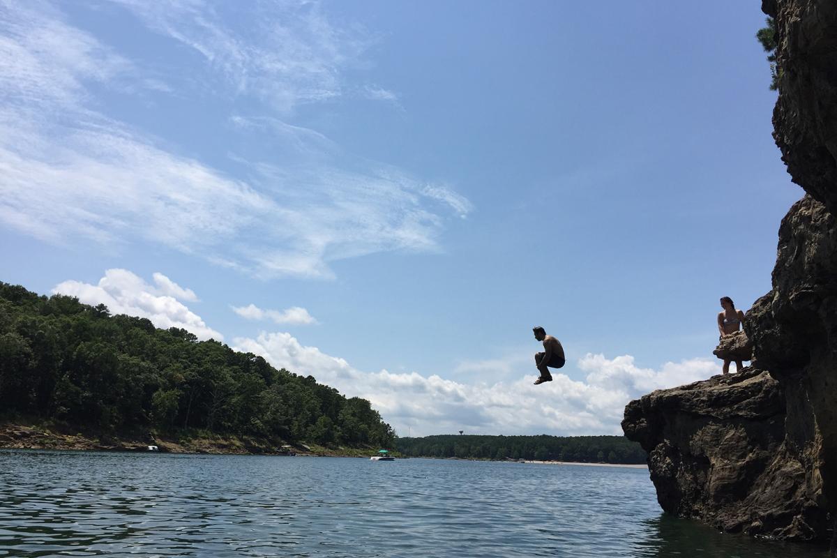 Man doing a cannon ball into the lake