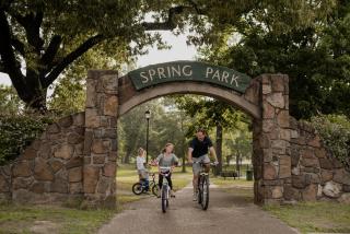 Family riding bikes in Spring Park